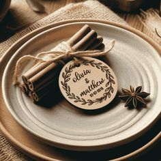 cinnamon sticks tied with twine on top of a plate next to an empty tag