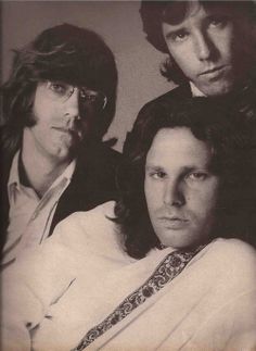 an old photo of three men with long hair