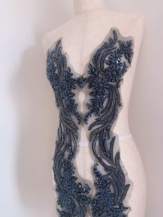 a mannequin with blue beading on it's torso and back part