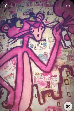 a pink cat is painted on the side of a wall