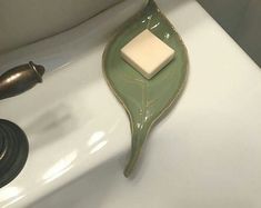 a bathroom sink with a faucet and soap dispenser on it