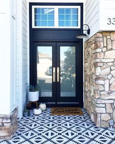 a black and white tiled entry way with two doors