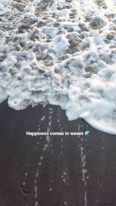 the water is foamy and has words written on it that read happiness comes in waves