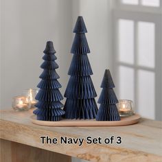 the navy set of 3 paper christmas trees are ready to be used as candlesticks