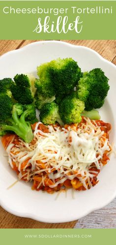 a white plate topped with pasta and broccoli on top of a wooden table