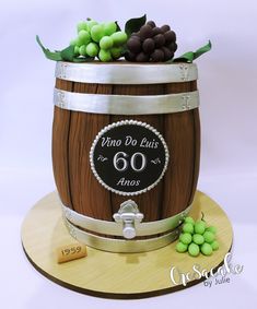 a cake made to look like a barrel with grapes in it and the number 60 on top