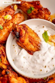 chicken wings with ranch dressing in a white bowl