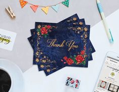 a thank you card sitting on top of a table next to a cup of coffee