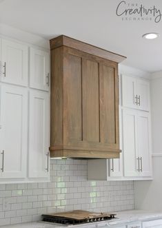 a kitchen with white cabinets and an oven