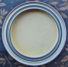 an empty tin can sitting on top of a blue table cloth