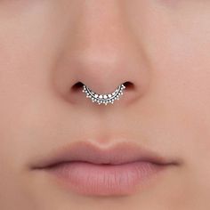 a woman's nose with a gold nose ring