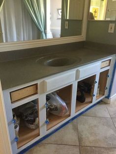 a bathroom with a sink and cabinets in it