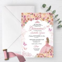 a pink and white wedding card on top of an envelope