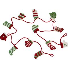 knitted christmas stockings and mittens hanging from red string