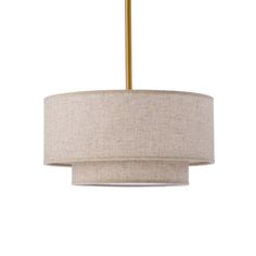 a light fixture with a beige fabric shade on the bottom and a gold metal rod