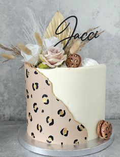 a cake decorated with leopard print and flowers