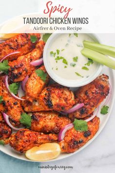 a plate full of chicken wings and garnished with cilantro, onion, and celery