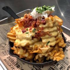 a bowl filled with waffles covered in cheese and bacon