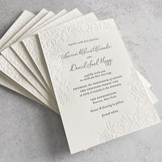 five white wedding cards on top of each other