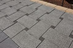 a close up view of a sidewalk made out of concrete blocks and cement pavers