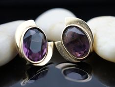 This is the perfect option for those who like cool, unique jewelry and the luxury, velvet shine of gold, violet. This earrings is well made, cute and/or elegant in design, and very desirable. The earrings have diamond smooth design . The earrings decorated with purple stones. The earrings have shape of oval. The earrings are stud. It is perfect for a gift for birthday, mother's day and holidays. ❤️ The earrings are 3/4'' by 5/16''. ❤️ There is a hallmark: 14K. ❤️The weight is about 4.6 g. ❤️The Contemporary Formal Jewelry With Gemstones, Contemporary Gemstone Jewelry For Formal Occasions, Contemporary Formal Gemstone Jewelry, Modern Amethyst Gemstone Earrings, Modern Purple Gemstone Earrings, Modern Amethyst Earrings As Gift, Art Deco Jewelry Vintage, Art Deco Gold, Purple Decor