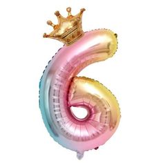 the number six balloon with a crown on top is pink, blue, and gold