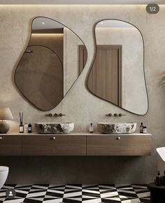 a bathroom with two sinks and mirrors on the wall