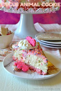 a piece of cake on a plate with sprinkles and pink icing