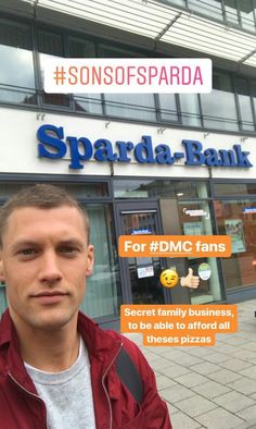 a man standing in front of a building with the words sparda bank on it