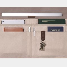 an open pocket with keys, wallets and other items in it that is attached to a tablet