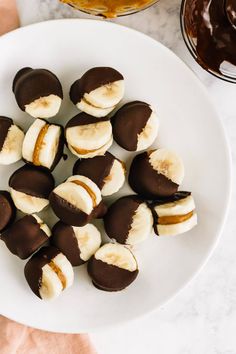 a white plate topped with chocolate covered bananas