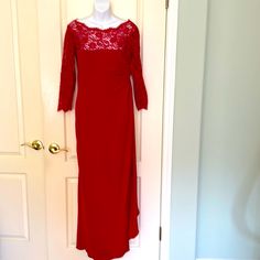 a red dress hanging on a white door