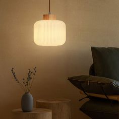 a living room scene with focus on the light fixture and two small vases sitting next to each other