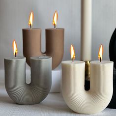 three candles sitting next to each other on a table