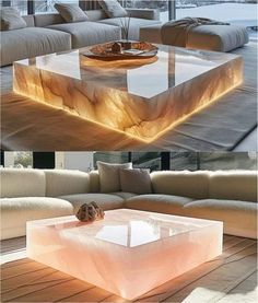 an unusual coffee table made out of marble blocks and led lighting on the top, in front of a living room couch