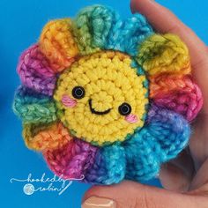 a small crocheted flower with a smiley face