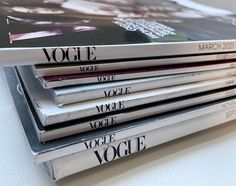 a stack of magazines sitting on top of a table