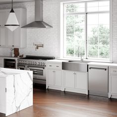 a white kitchen with marble counter tops and stainless steel appliance in the center