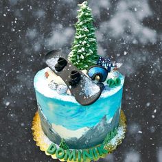 there is a cake decorated to look like a snowboarder on top of it