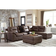 a living room with a sectional couch and ottoman