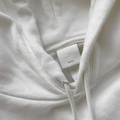 a white hoodie with a tag on it