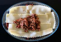 a plate with ravioli and meat sauce on the top, ready to be eaten