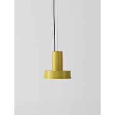 a yellow pendant light hanging from a ceiling