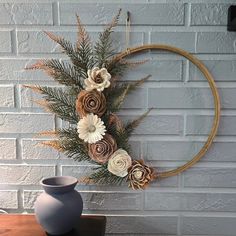 a blue vase sitting on top of a wooden table next to a white brick wall