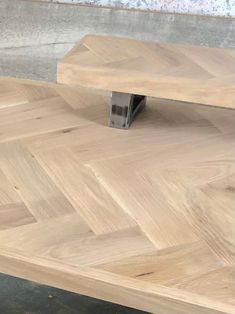 a wooden bench sitting on top of a hard wood floor