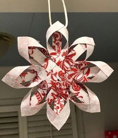 a red and white ornament hanging from a ceiling