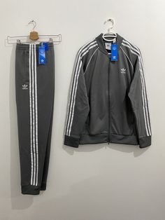 Jacket: Regular fit Ribbed collar 60% recycled polyester, 40% cotton interlock Heavyweight fabric Classic adidas track jacket Front zip pockets Ribbed cuffs and hem Pants: Slim fit Elastic waist with drawcord 60% recycled polyester, 40% cotton interlock Heavyweight fabric Tapered track pants Front zip pockets Ribbed cuffs Tapered legs Please check before you buy: *** Please make sure your address is correct.  I Will charge extra shipping if package is refused or non-deliverable*** Please be happy to send me any question you have: about the shipping options, discounts etc. Shipping Delays in standard and economy shipping may occur duo to lack of flights. Please understand. Import duties, custom fees, taxes and VAT charges are the buyer's responsibility. For USA buyers:  If you choose Standa Classic Adidas, Hem Pants, Adidas Tracksuit, Adidas Track Jacket, Mens Casual Dress Outfits, Adidas Track, How To Hem Pants, Mens Casual Dress, Mens Casual