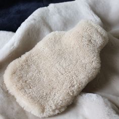 Made in Somerset, England, UK these cosy sheepskin hot water bottle covers are a must-have! This standard bottle cover slips on easily and is refiled through an opening on the top. These shearling covers are ideal to gently ease and warm, muscle pain, in your back, shoulder, and toes. You can be assured that even the hottest bottle will not burn and the dense sheepskin keeps the bottle warm all night long.  The hot water bottle is not included with the cover. Material - 100% Sheepskin  General c Fur Hot Water Bottle, Hot Water Bottle Aesthetic, Bottle Covers, Somerset England, Hot Water Bottle Cover, Water Bottle Covers, Bottle Warmer, Hot Water Bottle, Bottle Cover