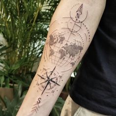 a man with a tattoo on his arm has a world map and arrows drawn on it