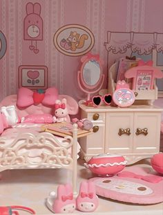 a doll house bedroom with pink furniture and accessories